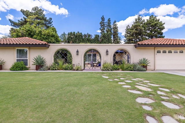 401 Via Carisma, Bakersfield, CA 93309 - mediterranean / spanish-style home with stucco siding, a front yard, a garage, and a tiled roof