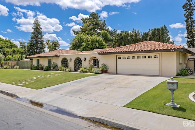 401 Via Carisma, Bakersfield, CA 93309 - mediterranean / spanish house featuring a garage, stucco siding, a tiled roof, and driveway