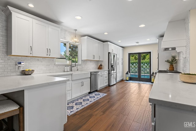 401 Via Carisma, Bakersfield, CA 93309 - kitchen with stainless steel appliances, a sink, white cabinets, decorative backsplash, and recessed lighting