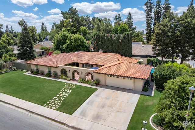 401 Via Carisma, Bakersfield, CA 93309 - mediterranean / spanish house with a tile roof, stucco siding, an attached garage, and concrete driveway
