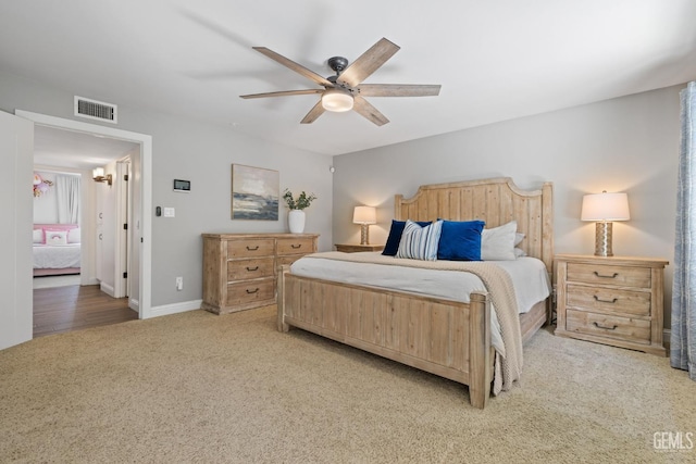 401 Via Carisma, Bakersfield, CA 93309 - bedroom with light colored carpet, a ceiling fan, and baseboards