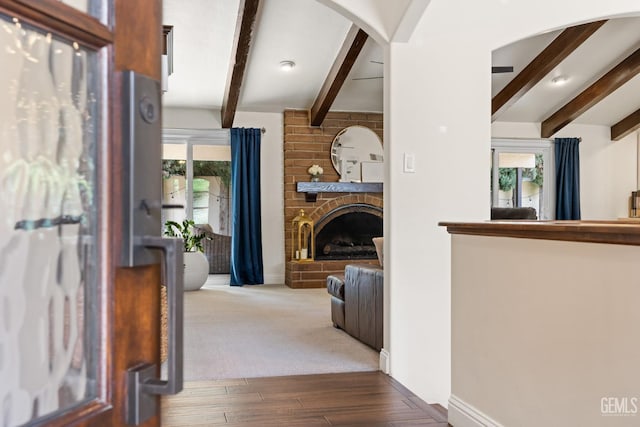 401 Via Carisma, Bakersfield, CA 93309 - entrance foyer featuring beam ceiling, healthy amount of natural light, a fireplace, wood finished floors, and baseboards