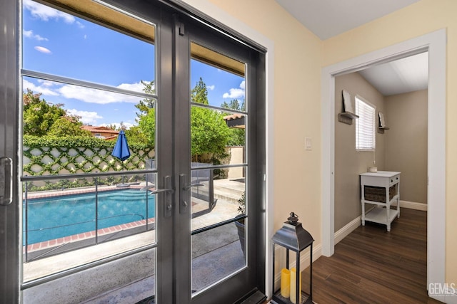401 Via Carisma, Bakersfield, CA 93309 - doorway to outside featuring french doors, dark wood-type flooring, and baseboards