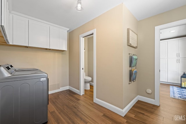 401 Via Carisma, Bakersfield, CA 93309 - washroom with cabinet space, washing machine and dryer, baseboards, and dark wood-style flooring