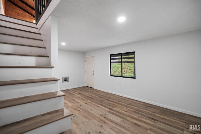24501 Pueblo Ct, Tehachapi, CA 93561 - staircase featuring recessed lighting and wood finished floors