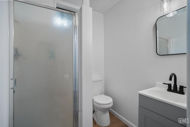 24501 Pueblo Ct, Tehachapi, CA 93561 - full bath featuring vanity, a shower stall, wood finished floors, and a textured ceiling