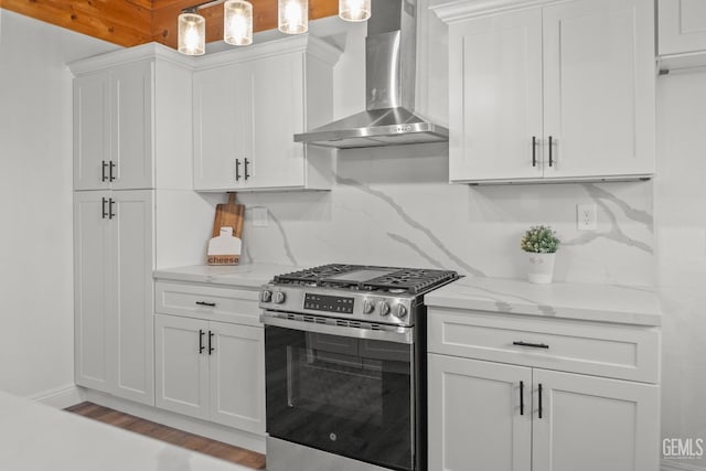 24501 Pueblo Ct, Tehachapi, CA 93561 - kitchen with stainless steel gas range, wall chimney exhaust hood, white cabinets, light stone counters, and tasteful backsplash