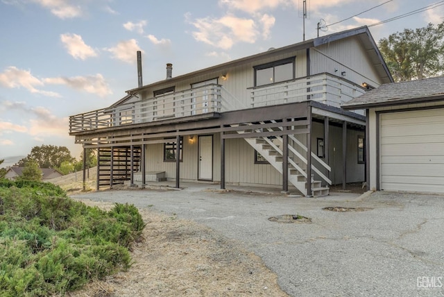 24501 Pueblo Ct, Tehachapi, CA 93561 - view of front of property with stairway, a wooden deck, and asphalt driveway