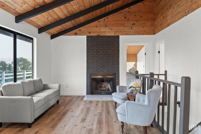 24501 Pueblo Ct, Tehachapi, CA 93561 - living room featuring healthy amount of natural light, wooden ceiling, wood finished floors, and a brick fireplace