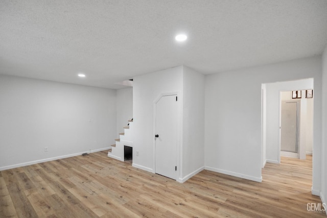 24501 Pueblo Ct, Tehachapi, CA 93561 - basement with stairs, light wood-style floors, and recessed lighting