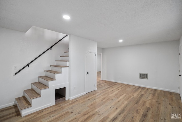 24501 Pueblo Ct, Tehachapi, CA 93561 - basement with stairway, light wood-type flooring, and recessed lighting