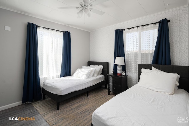 bedroom featuring dark wood-type flooring, ceiling fan, and ornamental molding