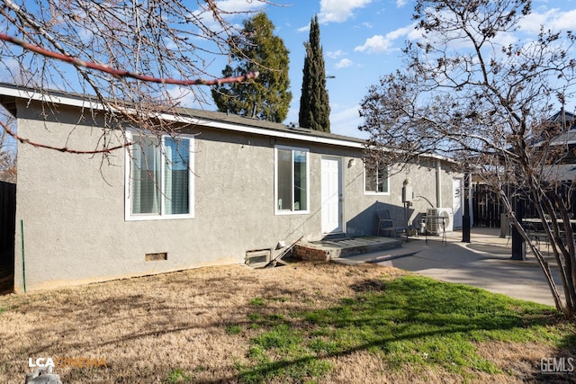 back of property featuring a lawn and a patio