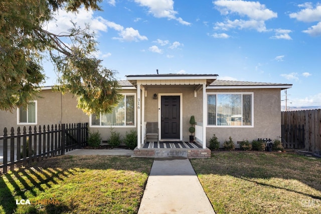 bungalow-style house with a front yard