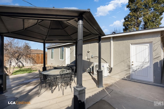 view of patio featuring a gazebo and ac unit