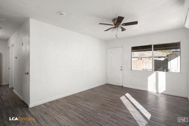 spare room with dark wood-type flooring and ceiling fan