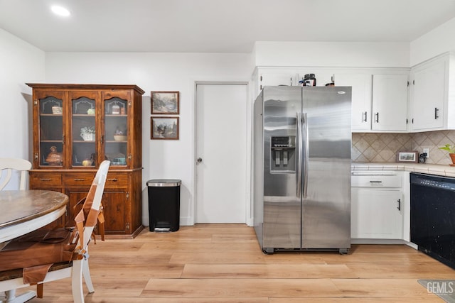 6101 Crestmore St, Bakersfield, CA 93308 - kitchen featuring stainless steel fridge, tile counters, black dishwasher, light wood-style floors, and recessed lighting