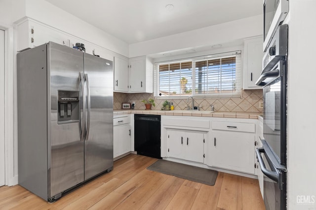6101 Crestmore St, Bakersfield, CA 93308 - kitchen featuring stainless steel fridge with ice dispenser, black dishwasher, white cabinets, and tasteful backsplash