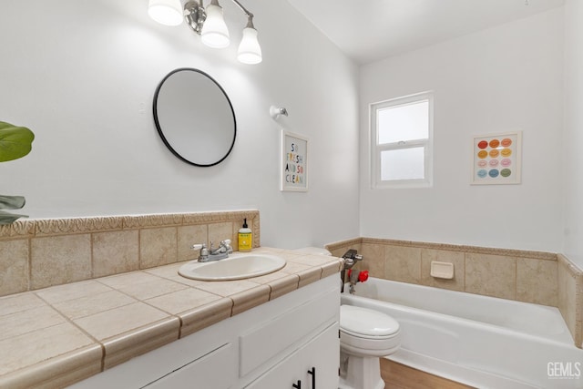 6101 Crestmore St, Bakersfield, CA 93308 - full bathroom featuring vanity, a garden tub, and wood finished floors