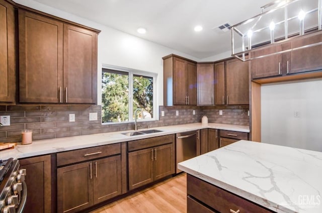 18671 Buckeye Pl, Tehachapi, CA 93561 - kitchen featuring stainless steel appliances, light stone countertops, decorative backsplash, light wood-style flooring, and recessed lighting