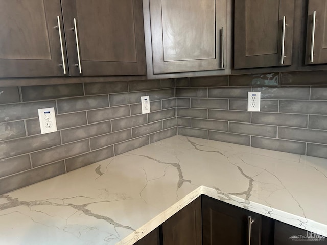 18671 Buckeye Pl, Tehachapi, CA 93561 - kitchen view of dark brown cabinetry, tasteful backsplash, and light stone countertops
