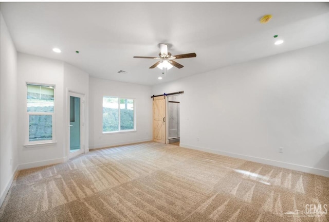 18671 Buckeye Pl, Tehachapi, CA 93561 - unfurnished room featuring light carpet, a barn door, a smoke detector, ceiling fan, and recessed lighting