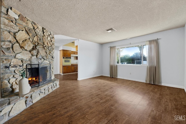 unfurnished living room featuring a fireplace and a textured ceiling