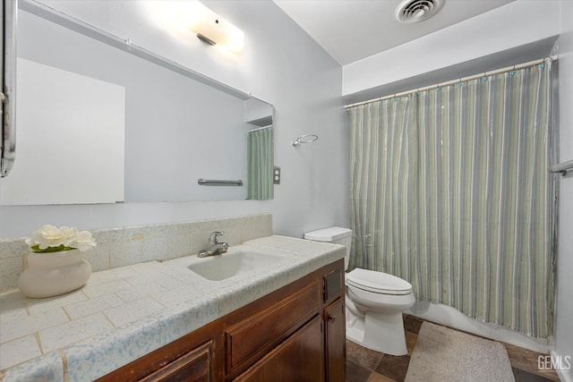 full bathroom featuring vanity, shower / bath combo, and toilet