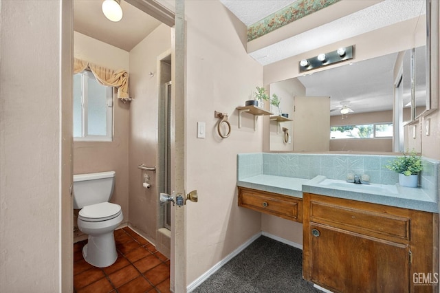 bathroom with tile patterned flooring, vanity, toilet, and tasteful backsplash