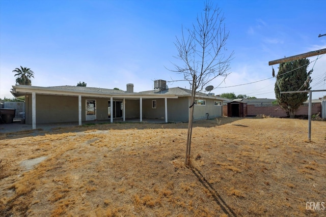 view of front of house with central AC and a storage unit