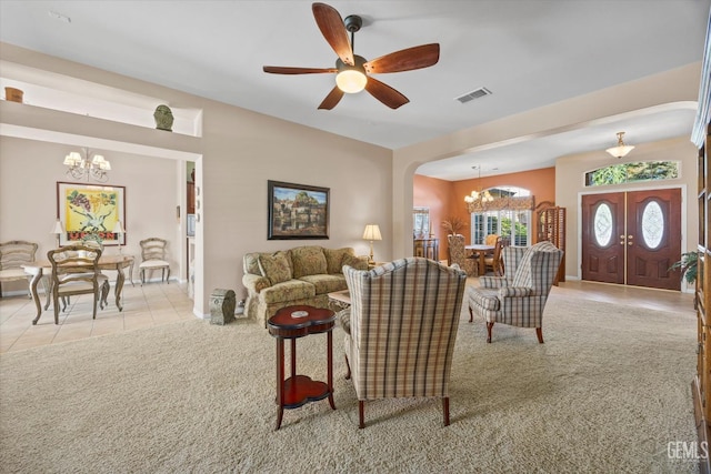 9005 Via Lugano, Bakersfield, CA 93312 - carpeted living area featuring a chandelier, tile patterned flooring, arched walkways, a ceiling fan, and baseboards
