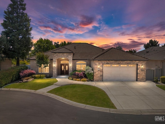 9005 Via Lugano, Bakersfield, CA 93312 - view of front of home with stone siding, a tile roof, an attached garage, and driveway