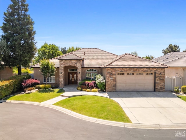 9005 Via Lugano, Bakersfield, CA 93312 - mediterranean / spanish-style house featuring stone siding, an attached garage, stucco siding, and concrete driveway