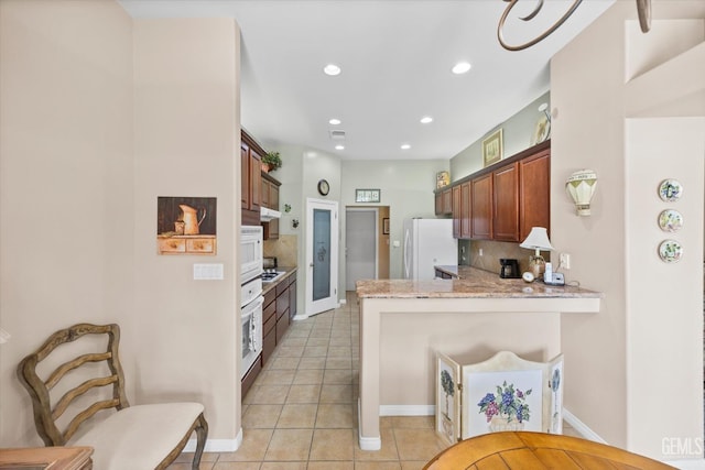 9005 Via Lugano, Bakersfield, CA 93312 - kitchen with a peninsula, backsplash, light tile patterned floors, white appliances, and recessed lighting