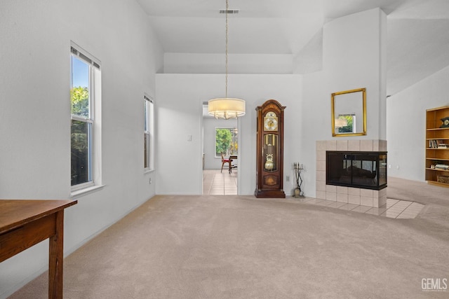 10400 Walnut Creek Ct, Bakersfield, CA 93311 - unfurnished living room featuring carpet floors, a high ceiling, and a tiled fireplace