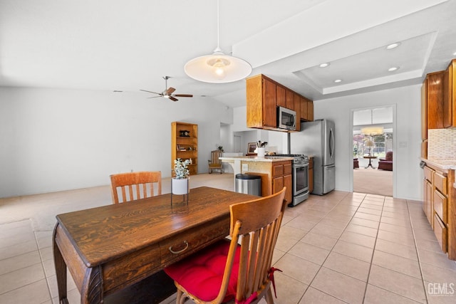 10400 Walnut Creek Ct, Bakersfield, CA 93311 - dining room with light tile patterned flooring, a ceiling fan, recessed lighting, a raised ceiling, and light colored carpet