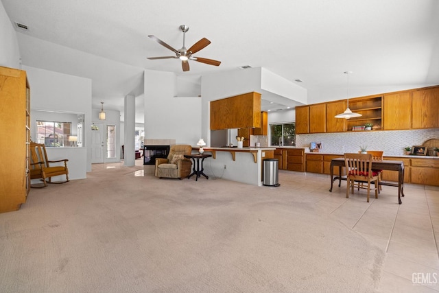 10400 Walnut Creek Ct, Bakersfield, CA 93311 - living area featuring vaulted ceiling, a ceiling fan, and light colored carpet