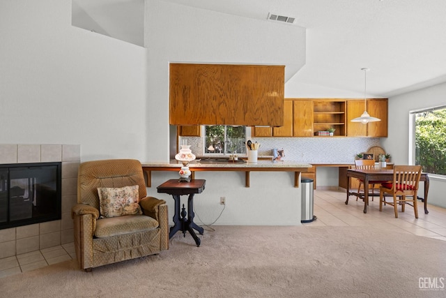 10400 Walnut Creek Ct, Bakersfield, CA 93311 - kitchen featuring brown cabinets, vaulted ceiling, open shelves, a breakfast bar area, and backsplash