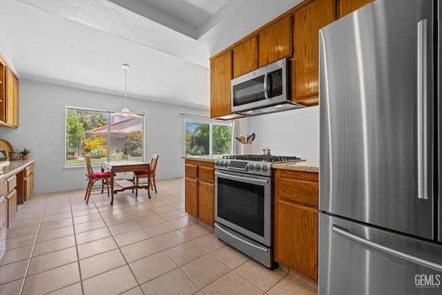 10400 Walnut Creek Ct, Bakersfield, CA 93311 - kitchen with appliances with stainless steel finishes, brown cabinets, and plenty of natural light
