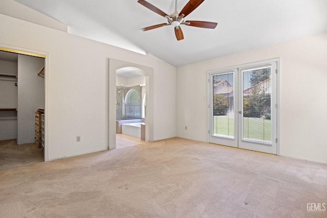 10400 Walnut Creek Ct, Bakersfield, CA 93311 - unfurnished bedroom featuring access to outside, carpet, vaulted ceiling, arched walkways, and a walk in closet