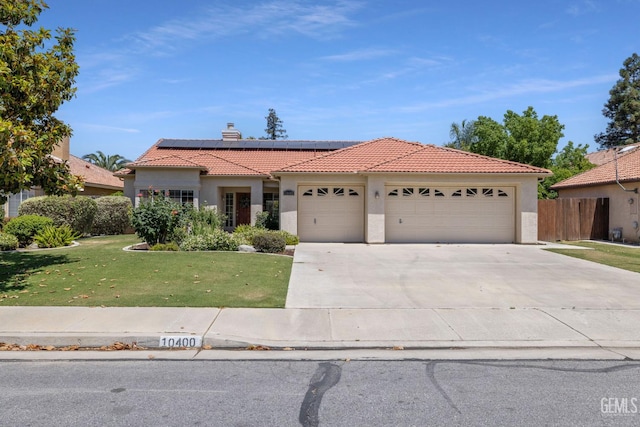 10400 Walnut Creek Ct, Bakersfield, CA 93311 - mediterranean / spanish home with a tiled roof, a garage, stucco siding, roof mounted solar panels, and driveway