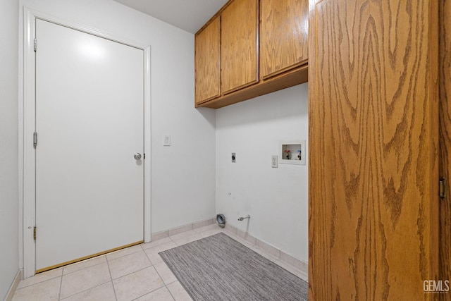 10400 Walnut Creek Ct, Bakersfield, CA 93311 - laundry room featuring hookup for a washing machine, cabinet space, electric dryer hookup, light tile patterned floors, and baseboards