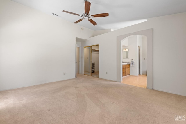 10400 Walnut Creek Ct, Bakersfield, CA 93311 - unfurnished bedroom featuring arched walkways, light carpet, lofted ceiling, ensuite bathroom, and ceiling fan