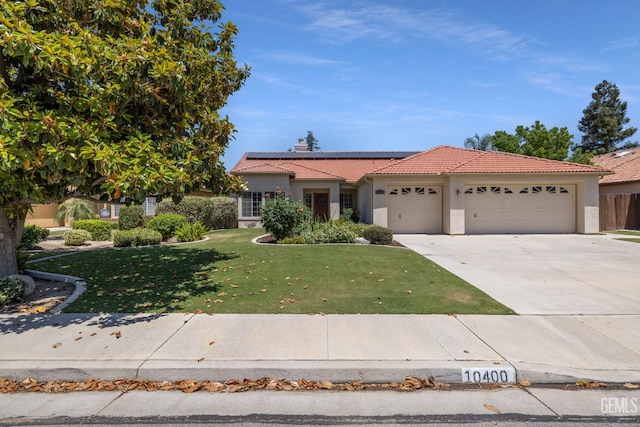 10400 Walnut Creek Ct, Bakersfield, CA 93311 - view of front of property featuring a tile roof, a garage, stucco siding, roof mounted solar panels, and a front lawn