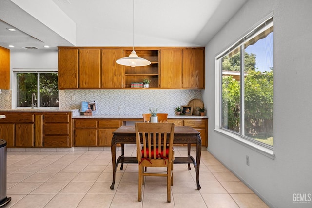 10400 Walnut Creek Ct, Bakersfield, CA 93311 - kitchen with brown cabinets, backsplash, vaulted ceiling, light countertops, and open shelves