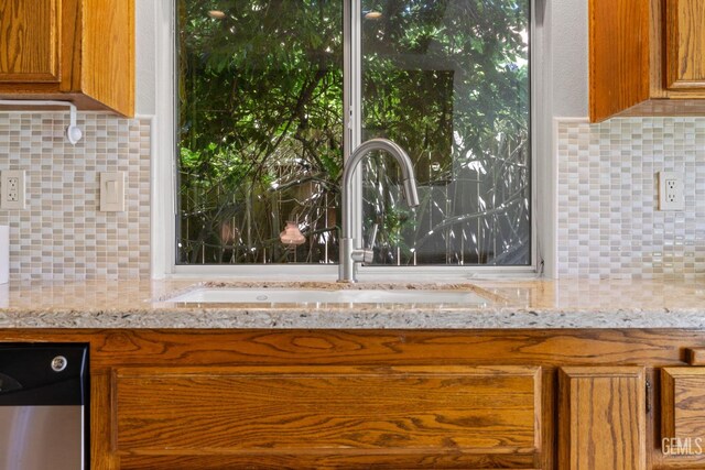 10400 Walnut Creek Ct, Bakersfield, CA 93311 - kitchen featuring decorative backsplash, brown cabinets, a sink, and dishwasher