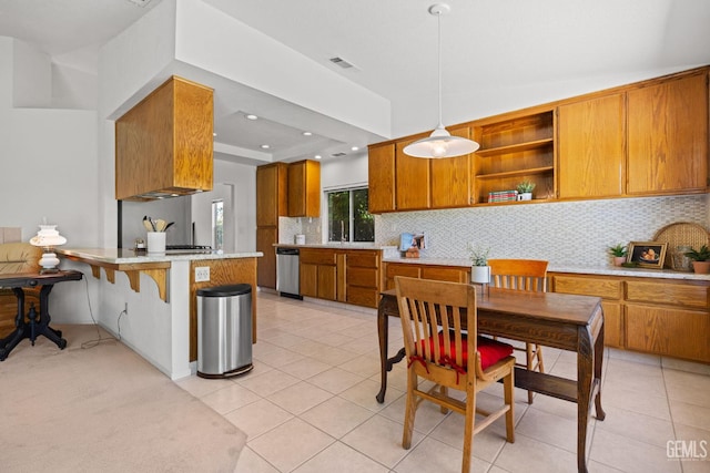 10400 Walnut Creek Ct, Bakersfield, CA 93311 - kitchen featuring stainless steel dishwasher, brown cabinets, tasteful backsplash, light countertops, and recessed lighting