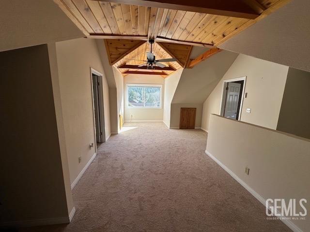 bonus room featuring ceiling fan, lofted ceiling with beams, light colored carpet, and wood ceiling