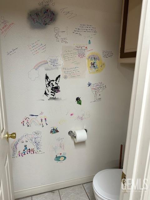 bathroom featuring tile patterned floors and toilet