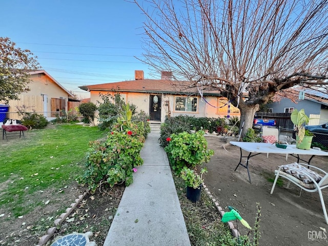 view of front of house featuring a front yard and a patio area